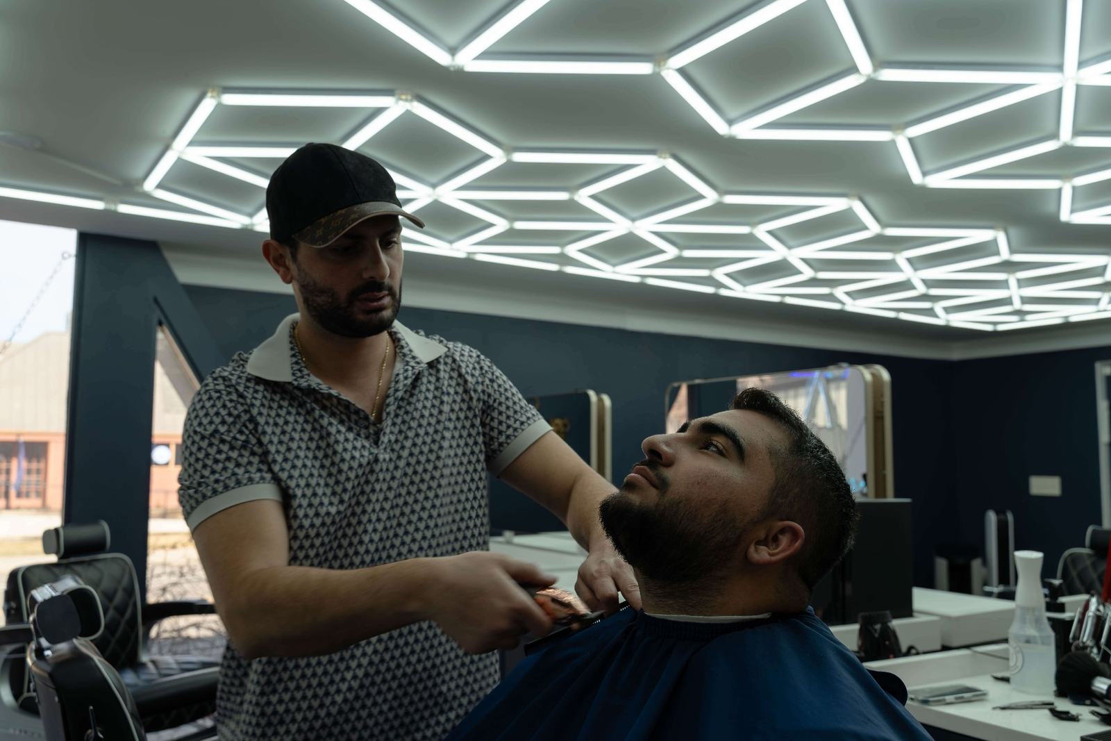 Barber performing precision beard lineup and neck shaping service at Cherry Barbers Cherry Creek Denver Colorado
