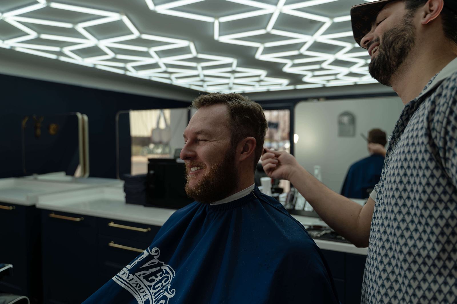 Professional mens haircut and styling at Cherry Barbers barbershop with LED honeycomb ceiling in Cherry Creek Denver