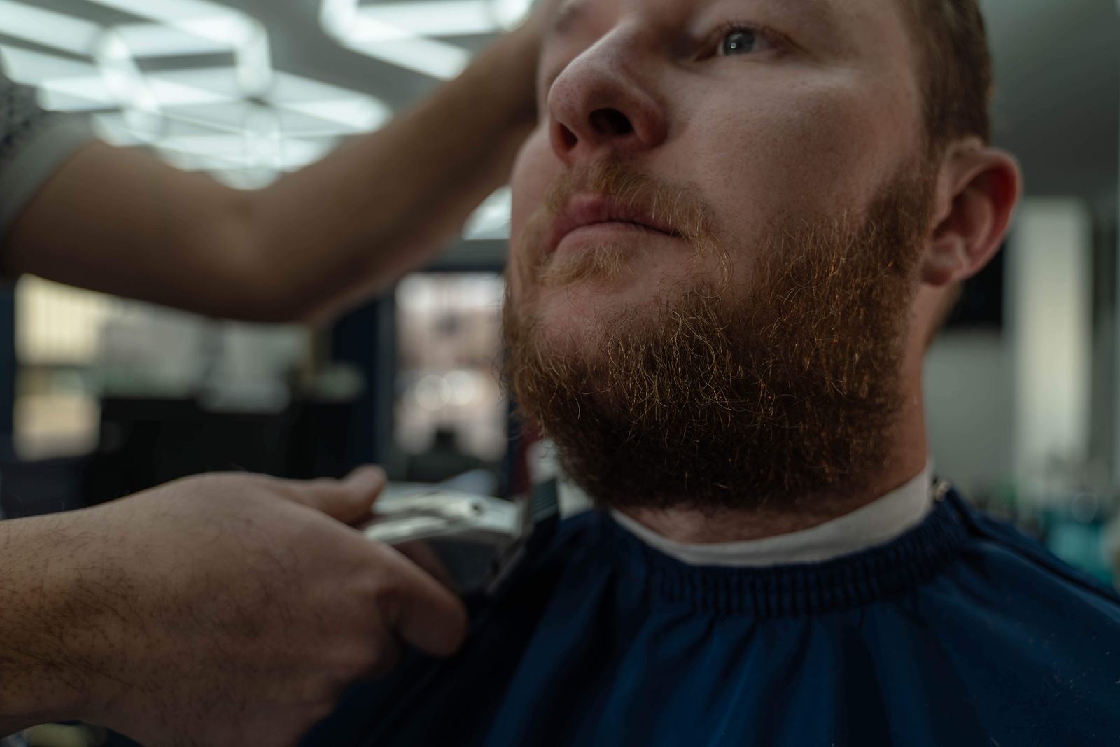 Barber performing precision beard grooming and shaping at Cherry Barbers barbershop Denver Glendale Colorado