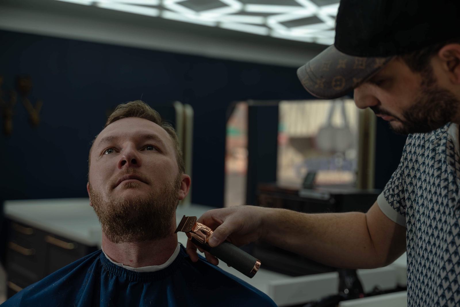 Master barber performing precision beard trim with professional clippers at Cherry Barbers in Glendale Denver